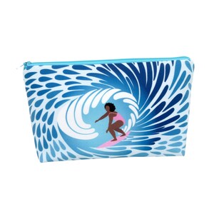 May include: A blue and white zippered pouch with a pattern of water droplets. The pouch features a graphic of a person surfing on a wave.