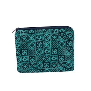 May include: A rectangular zippered pouch featuring a repeating grid pattern of dark navy blue and bright teal geometric shapes. The design consists of alternating squares containing stylized floral motifs, crosses, and circular arrangements.
