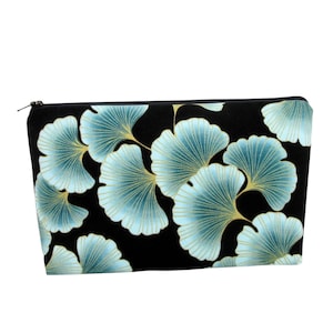 May include: Black zippered pouch with a blue and gold ginkgo leaf pattern.