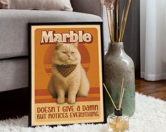 May include: A framed poster featuring a fluffy beige cat wearing a bandana. The poster has the word "Marble" at the top and the phrase "Doesn't Give a Damn But Notices Everything" at the bottom, set against an orange background with retro design elements.