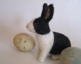 A bunny in black and white, needle felted animal sculpture