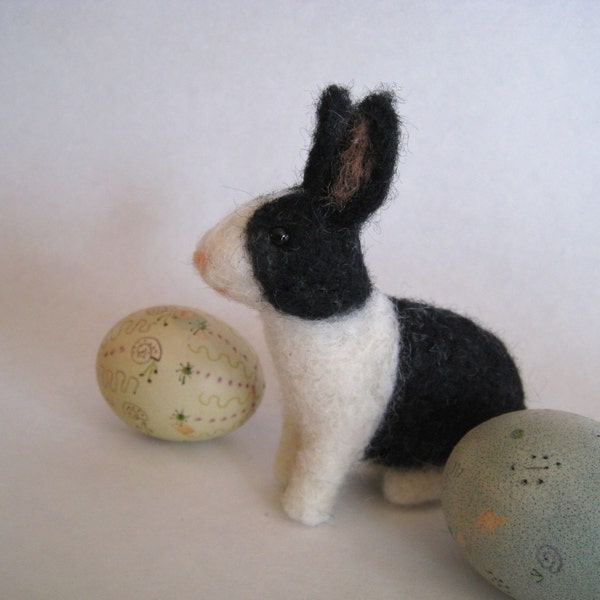 A bunny in black and white, needle felted animal sculpture