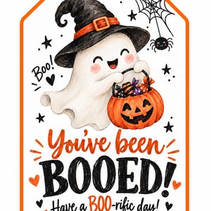 May include: A rectangular gift tag with an orange border featuring a white ghost wearing a black witch hat and holding an orange jack-o'-lantern bucket filled with candy. The text reads: You've been BOOED! Have a BOO-rific day! with spider web.
