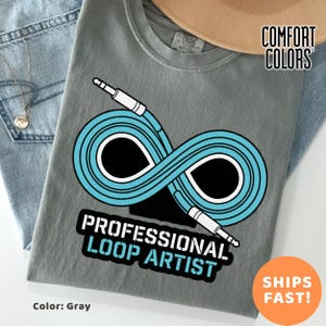 May include: Gray t-shirt with a blue and white infinity loop design, featuring the text "PROFESSIONAL LOOP ARTIST." The shirt is made of a soft material and is a Comfort Colors brand.