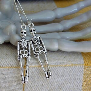 Skeleton earrings. teen tiny silver skeleton dangle earrings. halloween earrings . spooky earrings, scary earrings, death earrings