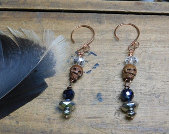 Gris Gris. Carved wood skulls, Quartz, and Glass Talisman earrings.