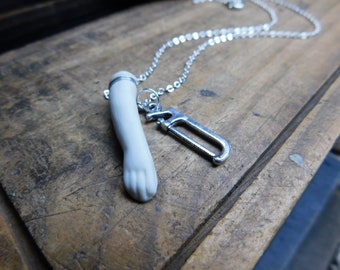 SeVereD. Porcelain Bisque doll arm & Hack saw necklace. Creepy weird macabre jewelry  #FestiveEtsyFinds