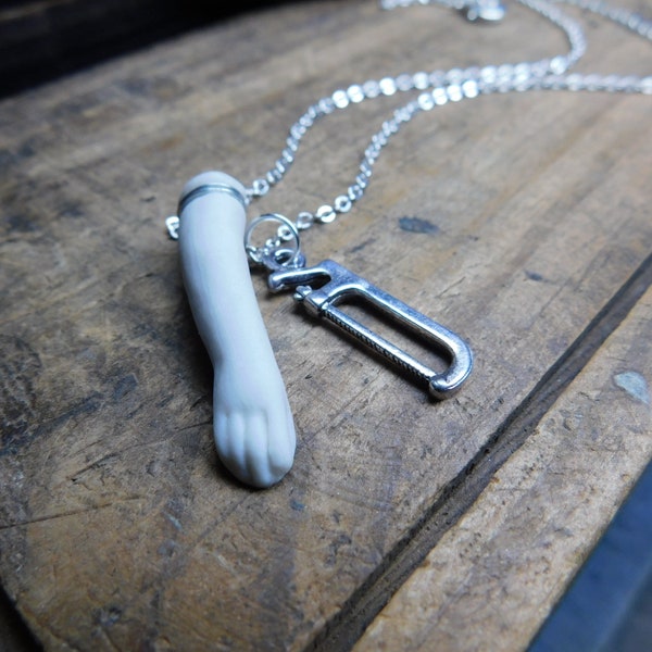 SeVereD. Porcelain Bisque doll arm & Hack saw necklace. Creepy weird macabre jewelry  #FestiveEtsyFinds
