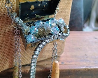 Pirate's Booty. Tiny Plastic Toy Treasure Chest, Vintage rhinestone bracelet, Fool's Gold, Paper Map beads, Bone Skulls, Sword, Vial, Pearls