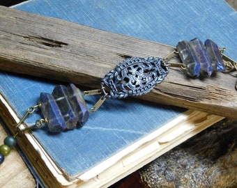 The Hela Bracelet. ROugh Raw Cobalt Blue titanium coated quartz , Gothic Black filigree center, and Glass beads one of a kind bracelet cuff