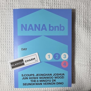 May include: A blue and light blue book with the text "NANA bnb" and "DAY". The numbers 1, 2, 3, and 4 are in circles. The names of the members of the group are listed below. A white sticker with the text "GLAMOUR CHARM LLC" is on the bottom left.