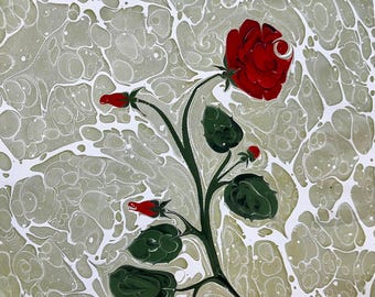 May include: A red rose with green leaves and buds painted on a white and green marbled background.