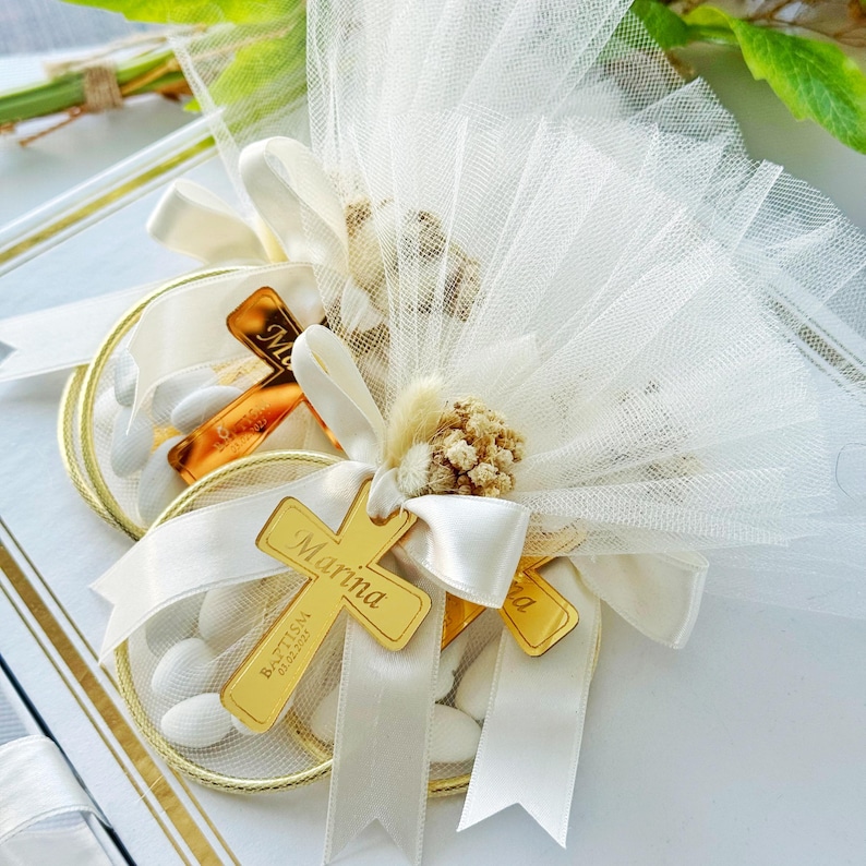 Personalized baptism favor with almonds and cross tag, wrapped in soft tulle and ribbon