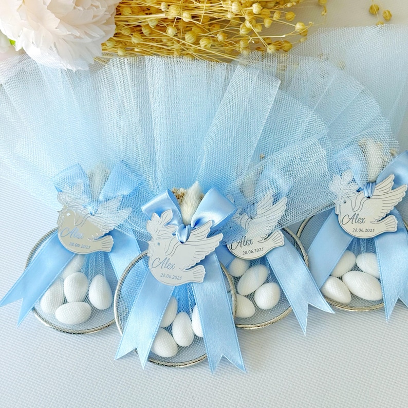 Elegant handmade bomboniere with white sugared almonds, satin bow, and personalized acrylic tag