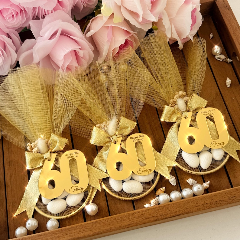 Beautiful birthday favor bag filled with almond candies, wrapped in elegant tulle and ribbon — perfect for milestone birthdays or party gifts