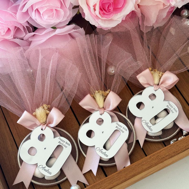Personalized tulle bag bomboniere with sugared almonds, ribbon, and custom age tag — Italian-style birthday favor keepsake for elegant celebrations
