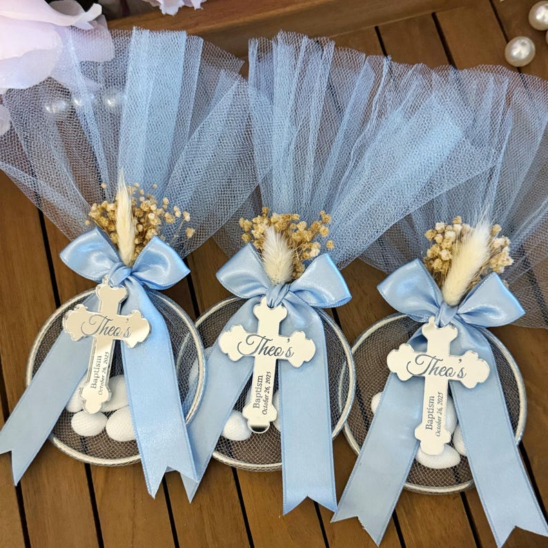 Handmade personalized almond candy bomboniere favor with tulle wrapping, satin ribbon bow, and dried flower decoration. Includes sugared almonds inside a round mesh base — perfect for baptism, christening, communion, or baby shower favors