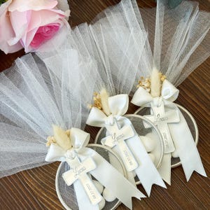 Handmade almond candy favor for baptism, communion, or baby shower, with ribbon and dried floral touch