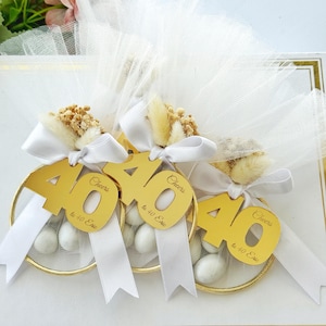 Custom Italian bomboniere favor — handmade with love, featuring tulle bag, sugared almonds, and personalized number charm for birthday celebration.