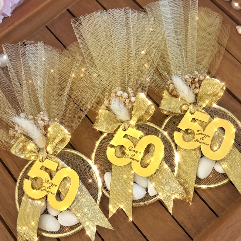 Elegant Italian bomboniere favor for milestone birthday, handmade with tulle bag, satin ribbon, dried flowers, and sugared almond candies — perfect 40th, 60th, or 80th birthday gift