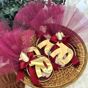 Handmade almond candy favor with gold number tag, dried floral detail, and soft tulle — unique Italian bomboniere for 60th birthday celebration