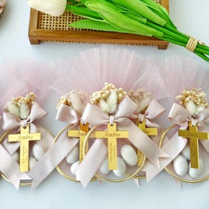 Custom christening favor with almonds, name tag, and decorative tulle — ideal for boys and girls