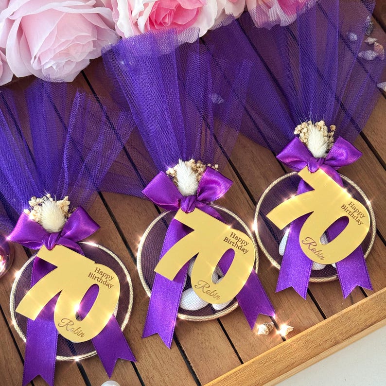 Luxury birthday bomboniere with number tag, gold or pink tulle wrapping, satin bow, and white almond candies — handmade favor gift for party guests.