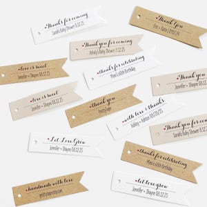 May include: A collection of white and brown paper gift tags with various messages, including "love is sweet", "let love grow", "thanks for celebrating", and "with love & thanks".