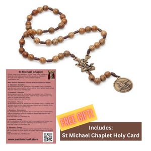 May include: A Saint Michael chaplet featuring brown wooden beads strung on a dark cord, a bronze-toned metal centerpiece depicting Saint Michael, and a matching circular medal. Includes a printed holy card with prayer text and a QR code.