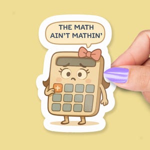 May include: A sticker depicting a cartoon calculator with a sad face and a pink bow. A speech bubble above the calculator says "THE MATH AIN'T MATHIN'." The sticker is held by a hand with purple nail varnish.