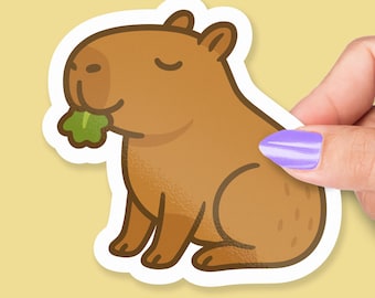 Sticker capibara eet sla: schattige kawaii-vinyl dierensticker voor planners of tijdschriften