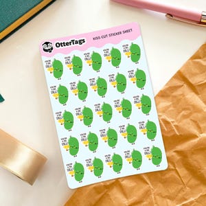 May include: A sheet of kiss-cut stickers featuring cartoon pickles with the text "You're a Big Dill!" The stickers are green with yellow accents and are arranged on a light blue background. The sheet is labeled "OtterTags KISS CUT STICKER SHEET."