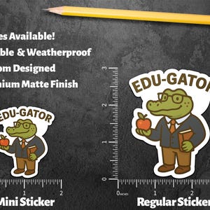 May include: Two stickers featuring a cartoon alligator wearing glasses, a suit, and holding an apple and a book. The stickers are labeled "EDU-GATOR" and are available in mini and regular sizes. The image also includes text that says "Durable & Weatherproof" and "Premium Matte Finish."