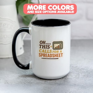 May include: White ceramic mug with a black handle and rim. The mug features the text "OH.... THIS + CALLS FOR A SPREADSHEET" in brown and gold. A graphic of a spreadsheet is also included. The top of the image reads "MORE COLORS AND SIZE OPTIONS AVAILABLE!"