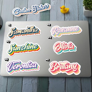 May include: A collection of custom stickers with names and the text "Custom Sticker". The stickers feature a retro design with a white border and colorful, layered text. Names include Samantha, Roxanne, Sunshine, Olivia, Veronica, and Brittany.
