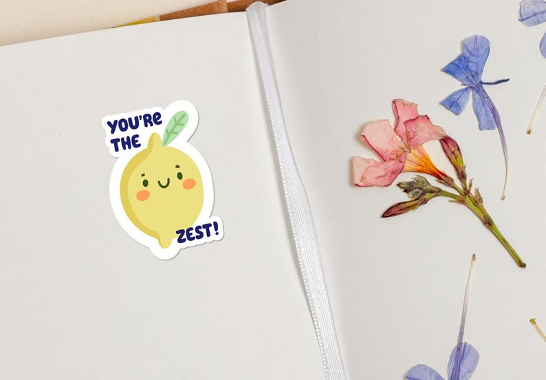 May include: A yellow lemon sticker with a smiling face and green leaves. The sticker says "You're the Zest!" in blue text.