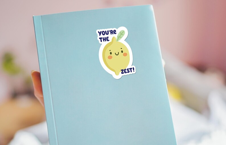 May include: A blue notebook with a yellow lemon sticker that says "You're the Zest!"
