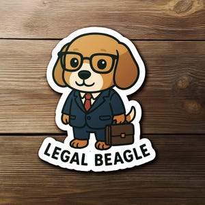 May include: A sticker featuring a cartoon beagle wearing glasses, a suit, and carrying a briefcase. The text "LEGAL BEAGLE" is printed below the beagle in a curved white banner. The beagle is brown and white, and the suit is navy blue.