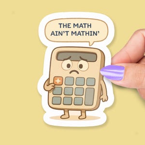 May include: A sticker featuring a cartoon calculator with a sad face and arms and legs. The calculator is beige with gray buttons and the text "THE MATH AIN'T MATHIN'" in a speech bubble.