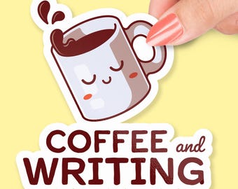 May include: A sticker featuring a cartoon coffee mug with closed eyes and a splash of coffee. The text "COFFEE and WRITING" is below the mug in a dark red font. The sticker is held by a hand against a yellow background.