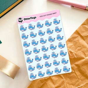 May include: A sheet of kiss-cut stickers featuring blue cartoon whales with the text "Whale Done!" above them. The stickers are on a light blue background, with the OtterTags logo at the top left.