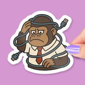 May include: A sticker featuring a cartoon gorilla wearing a white shirt, red tie, and a USB cable wrapped around its head and body. The gorilla has a concerned expression. The sticker is on a purple background.
