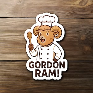 May include: A sticker featuring a cartoon ram wearing a chef's hat and uniform, holding a wooden spoon. The sticker has the text "GORDON RAM!" in brown letters. The background is a wooden surface.