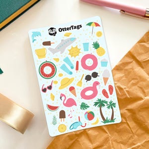 May include: A sheet of colorful summer-themed stickers with images of a flamingo, a pineapple, a watermelon, a beach umbrella, a plane, sunglasses, a beach ball, a bucket, a popsicle, an ice cream cone, a pair of flippers, a sun, a life preserver, a palm tree, and more. The sheet is titled "OtterTags".