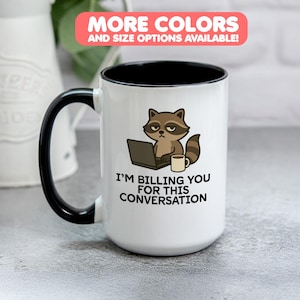 May include: White ceramic mug with a black handle and rim. The mug features a cartoon raccoon with a laptop and coffee cup, and the text "I'M BILLING YOU FOR THIS CONVERSATION". The top banner reads "MORE COLORS AND SIZE OPTIONS AVAILABLE!"