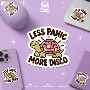 May include: A die-cut vinyl sticker featuring a light green cartoon turtle with a multi-colored disco ball shell. The text "LESS PANIC MORE DISCO" is printed in bold brown letters above and below the turtle. The design includes small radiating lines.