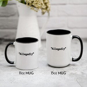 May include: Two white ceramic mugs with black interiors and handles. The mugs have the word "Allegedly" printed in black. One mug is labeled "11oz MUG" and the other is labeled "15oz MUG".