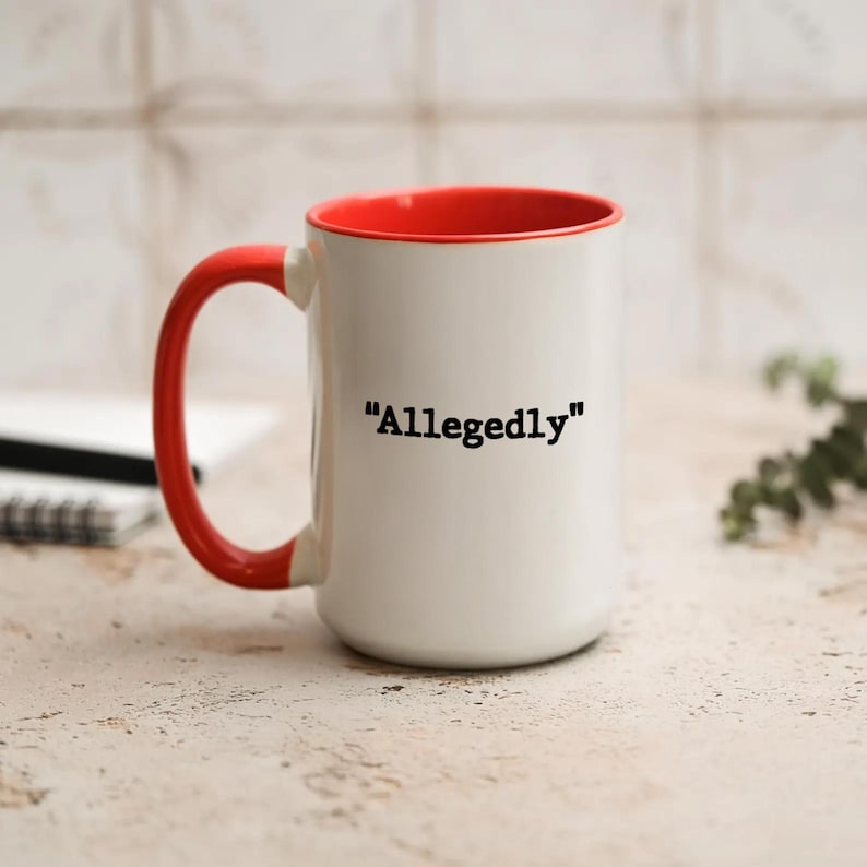 May include: White ceramic mug with a red interior and handle. The mug features the word "Allegedly" in black text. The mug is a standard size and suitable for hot or cold beverages.