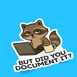 Puede incluir: Una pegatina con un mapache de dibujos animados con expresi&oacute;n de enfado frente a un port&aacute;til y una taza de caf&eacute;. El texto "BUT DID YOU DOCUMENT IT?" aparece sobre un fondo azul.