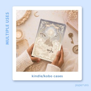 May include: A fantasy-themed Kindle/Kobo case with a castle, dragons, and the text "FLY OR DIE" and "THE RIGHT WAY ISN'T THE ONLY WAY." The case is held in hands, with a soft, neutral background.